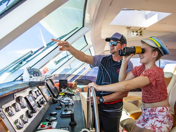 Girl with captain of Passions of Paradise on the Great Barrier Reef