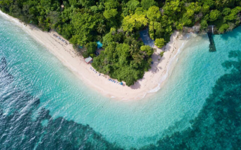 Aerial view of Green Island beach and rainforest surrounded by clear turquoise water