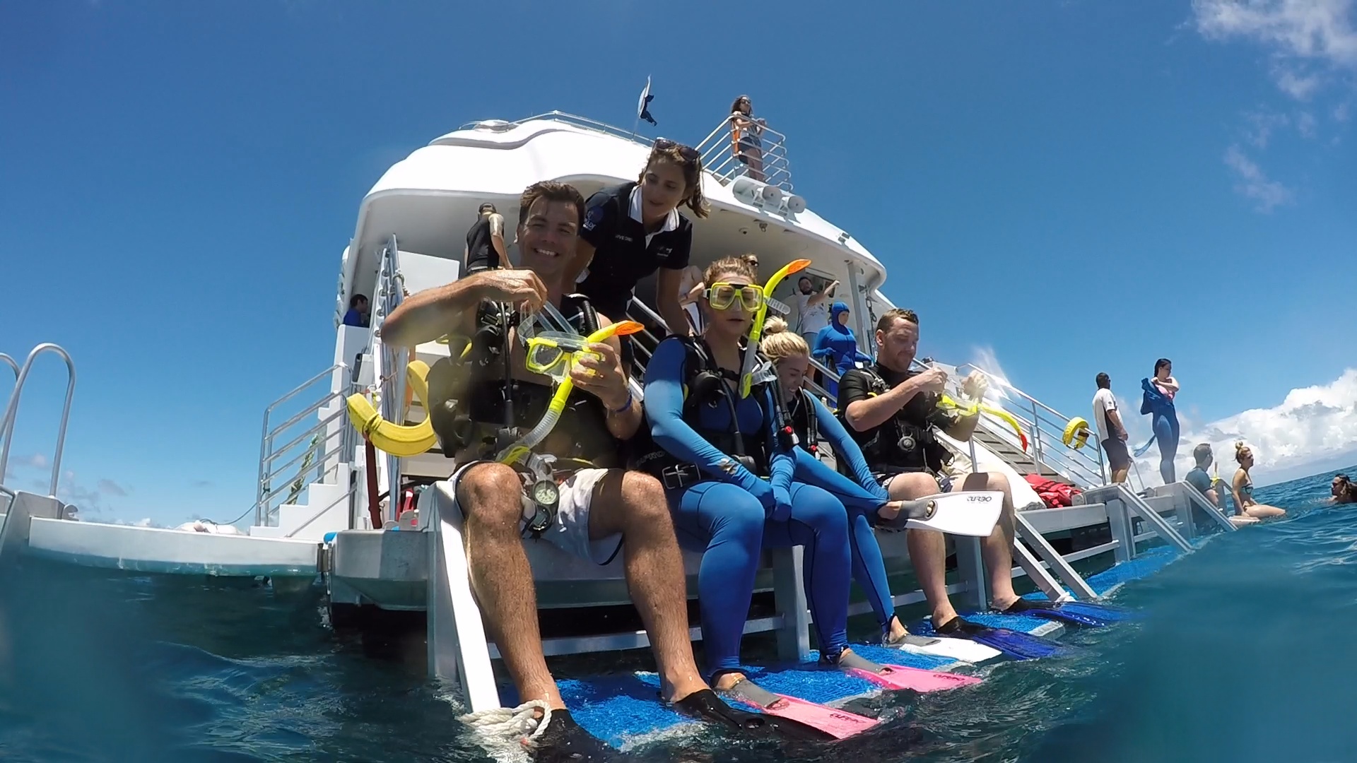 On the dive deck, the crew will fit you with a wetsuit, buoyancy control device (BCD), tank, weight belt, mask, and fins. Everything is provided - you bring your swimwear and nothing else. The crew will check your fit and runs through the regulator with you before you enter the water.
Entering the water