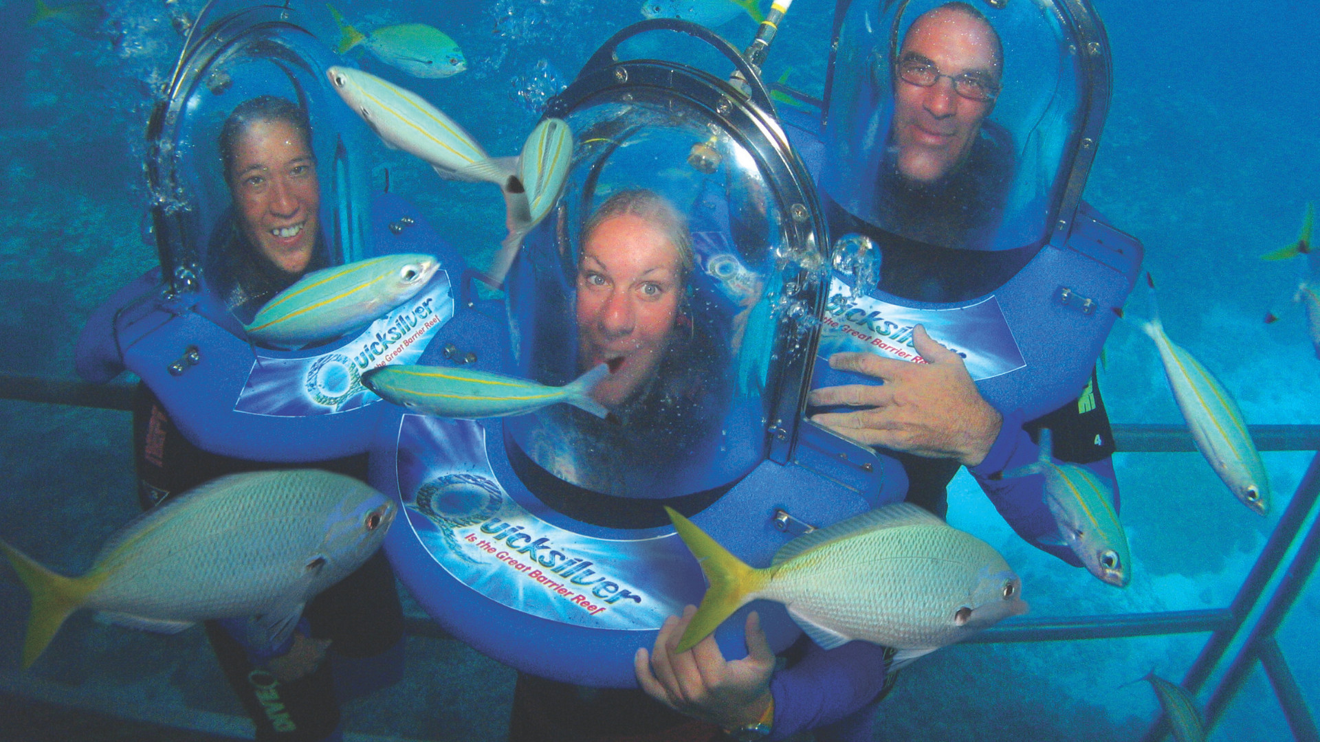 Seawalker helmet dive experience at Green Island with people walking underwater among fish