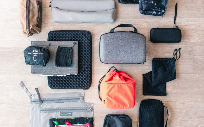 Flat lay of items to pack for a Great Barrier Reef day tour including bag and essentials