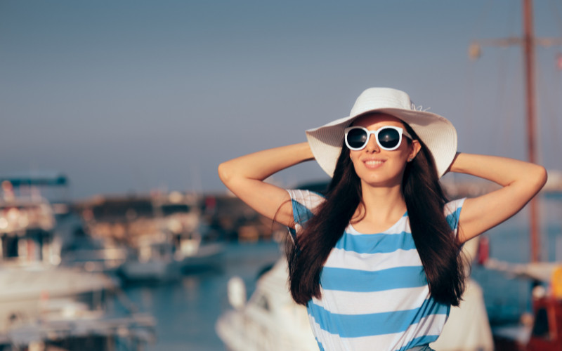Woman wearing sun hat and sunglasses on a Great Barrier Reef tour in Cairns