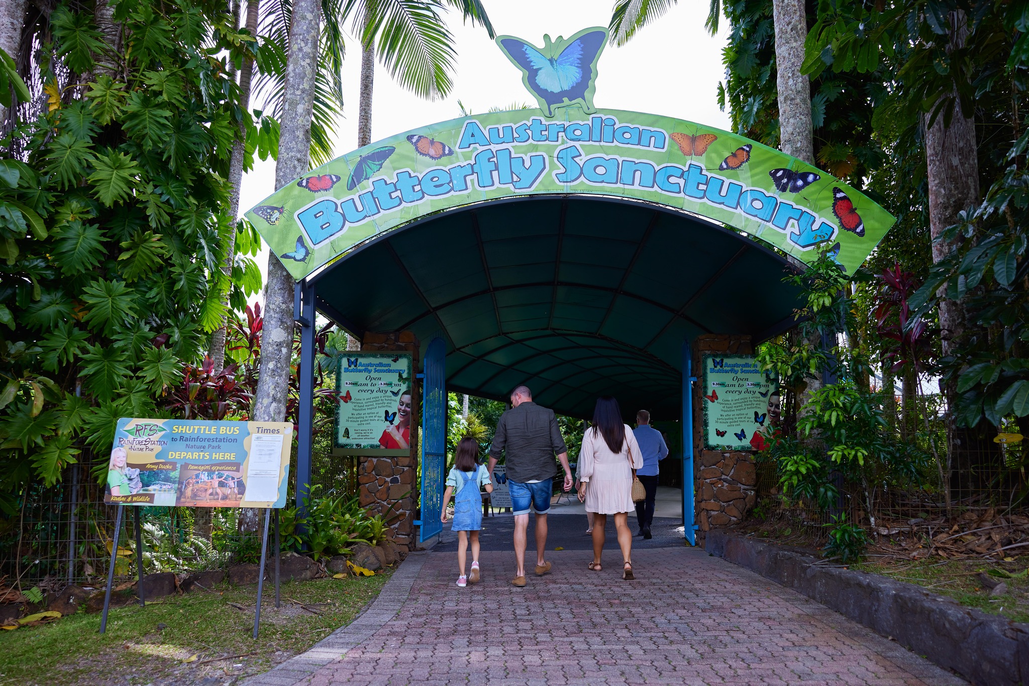 `Family entering Australian Butterfly Sanctuary entrance in Kuranda Village Queensland`