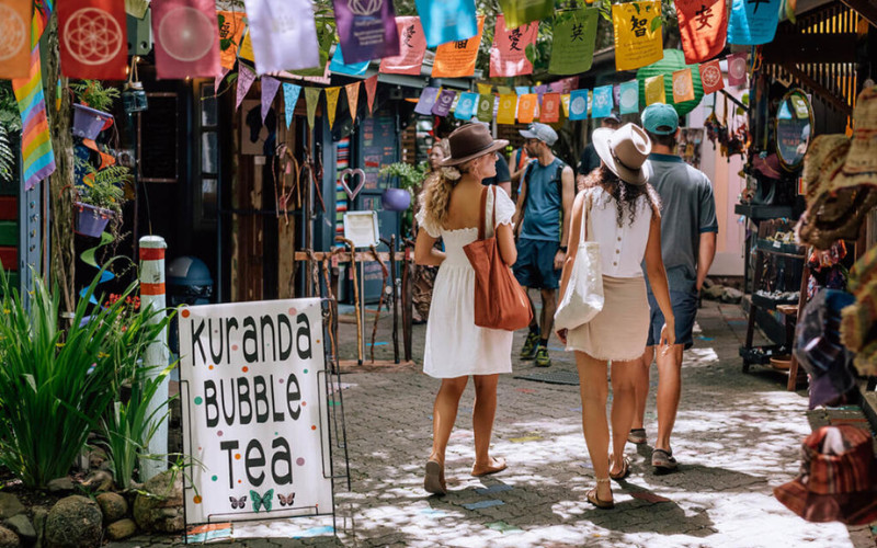 `Visitors exploring Kuranda Village markets and shops in tropical North Queensland Australia`