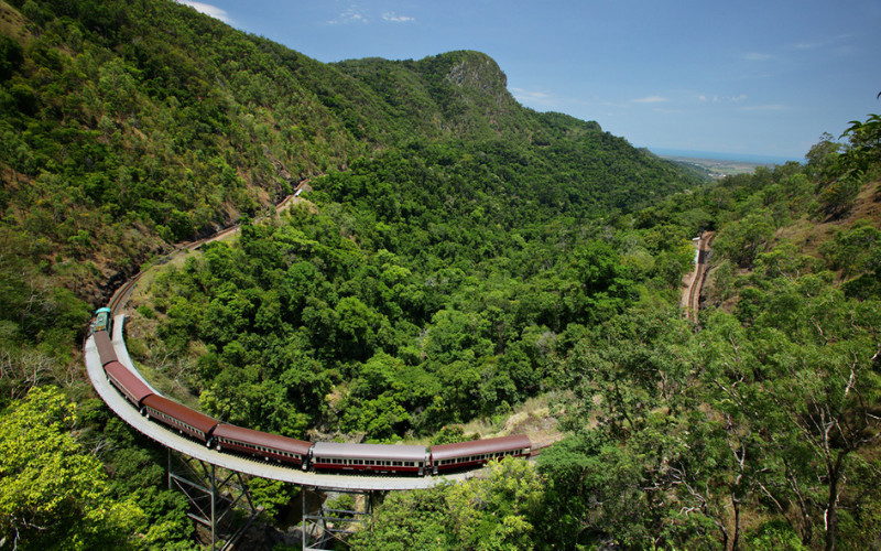 `Kuranda Scenic Railway winding through rainforest mountains near Cairns Queensland Australia`