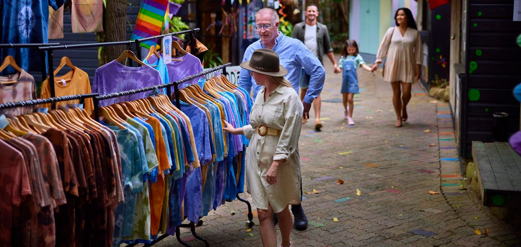 Shoppers browsing tie-dye clothing at Kuranda Heritage Markets Queensland Australia