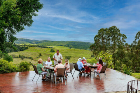 Group dining alfresco with panoramic Atherton Tablelands countryside views on a food and wine tour Queensland