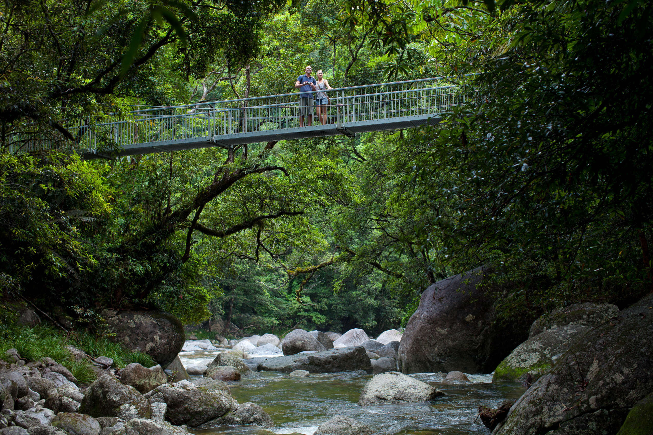 Suspension bridge over Mossman River granite boulders and rainforest walking tracks Queensland